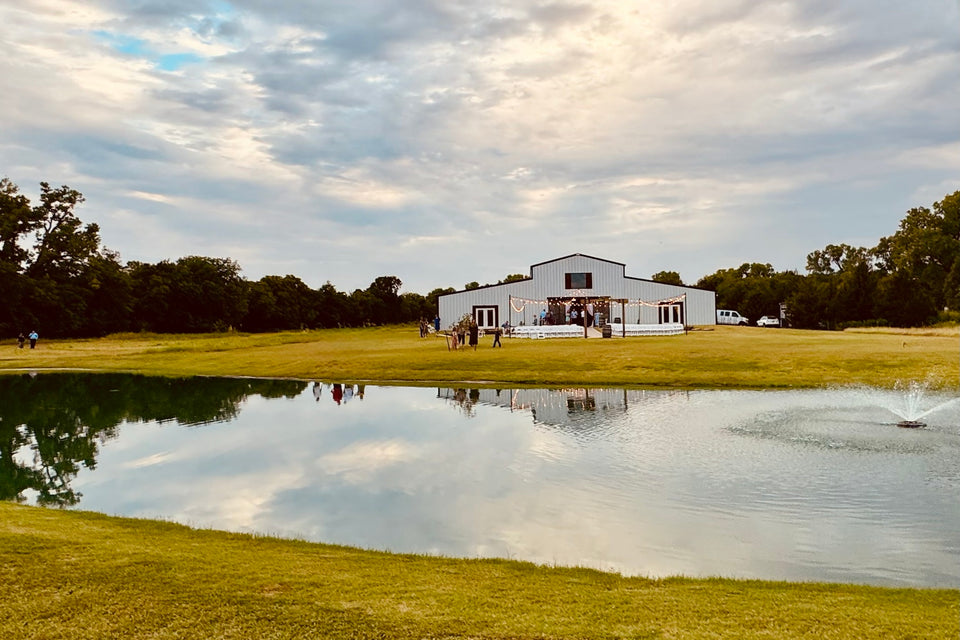 Pond and event venue near Luther under a cloudy sky