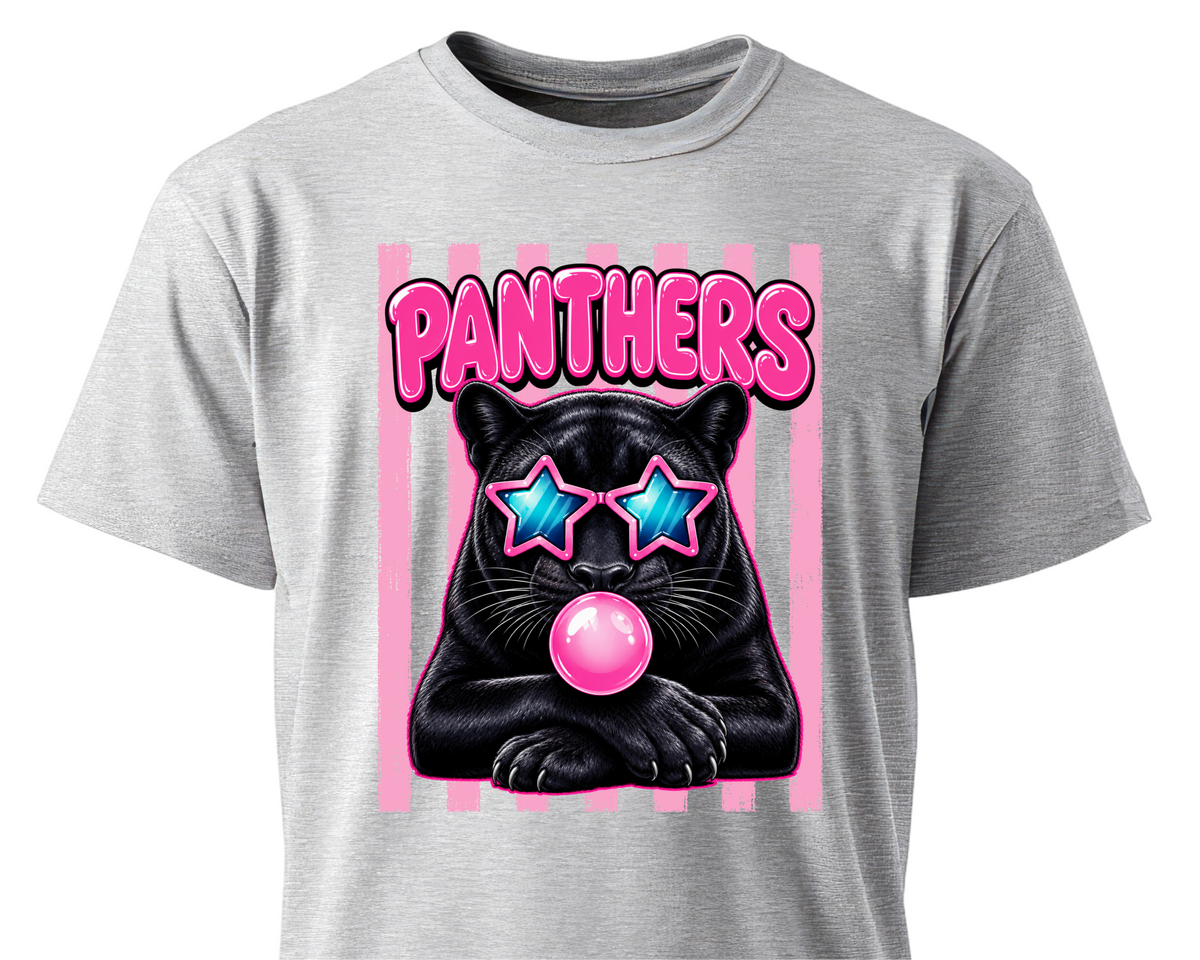 A heather gray short-sleeve t-shirt featuring a graphic print of a black panther wearing pink star-shaped sunglasses and blowing a pink bubblegum bubble, with the word 'PANTHERS' in pink above it.